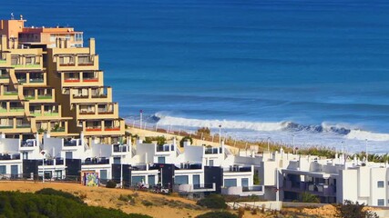 Urban coastal landscape showing contemporary housing developments near the shore with rolling surf, designed for tourism and investment content
