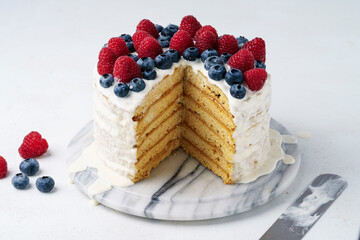 Light Honey Biscuit Cake with White Protein Cream and Fresh Berries, Close Up