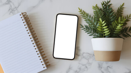 A serene workspace setup with a smartphone notebook and potted plant on a marble surface symbolizing productivity and harmony