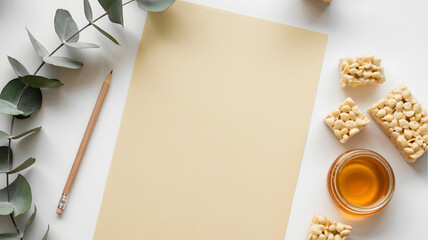 Blank paper with pencil honey and eucalyptus leaves on white background creative workspace setup with natural elements and textured