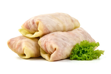 Three stuffed cabbage rolls with lettuce garnish, isolated on white background.