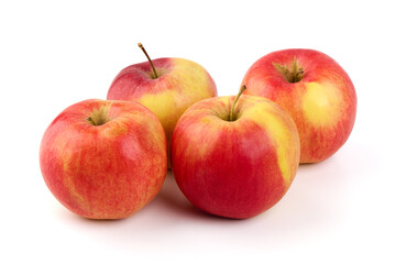 Four ripe red and yellow apples with stems displayed on a pure white surface, isolated on white background.