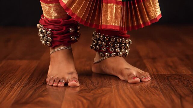 Feet of Indian Classical Dancer with Ghungroos on Wooden Floor