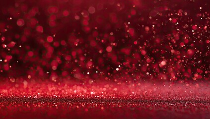 A close-up, out-of-focus view of red sparkles and dust motes