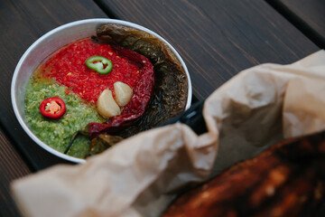 Overhead Flat Lay of Spicy Mediterranean Condiments including Red Chili Salsa, Green Herb Paste,...