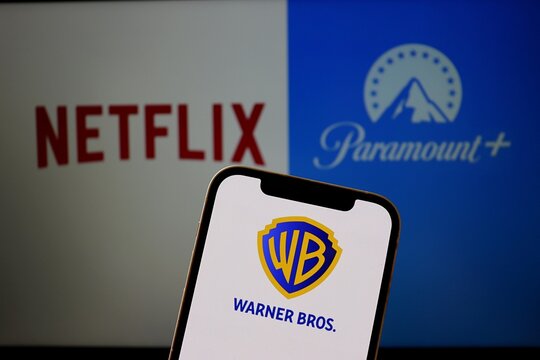 Salvador, Brazil - January 21, 2026: Warner Bros. logo on smartphone screen with Netflix and Paramount logos in the background. Netflix, Paramount and Warner Bros brands.