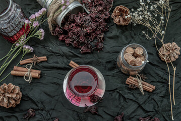 Roselle tea (Jamaica sorrel, Rozelle or hibiscus sabdariffa ) with dry roselle and brown cane sugar cube. Healthy herbal tea rich in vitamin C and minerals. The concept of health. Organic and Summer. © num