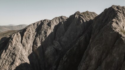 Jagged, rocky mountain range under a bright, cloudless, clear sky