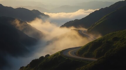 A long winding mountain road disappearing into the mist.