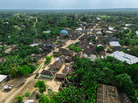 Aerial view of a dense, verdant landscape interlaces with clusters of dwellings, showcasing a vibrant tapestry of life, Ubarama, Rivers, Nigeria.