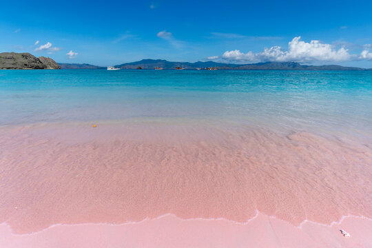 Pink beach on Komodo Island where soft blush sands blend with turquoise waters under a vivid sky in Indonesia&rsquo;s paradise.
