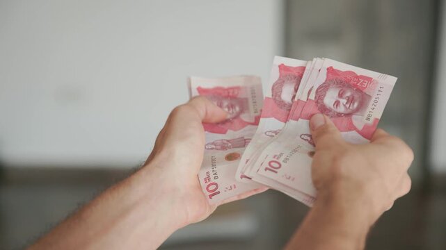 Hands Counting Ten Thousand Colombian Peso Bills Money Video Recorded in 4K at 60fps
