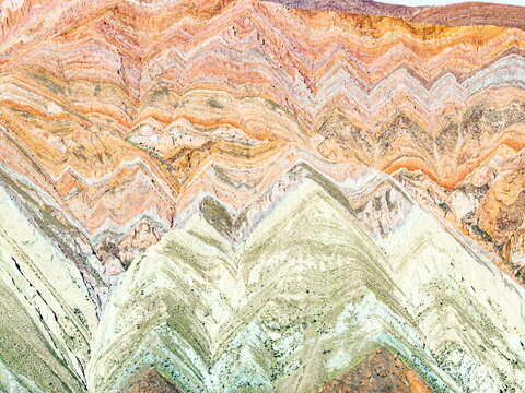 Aerial view of the stunning Quebrada de Humahuaca, where layers of vibrant earth paint a breathtaking geological tapestry, Humahuaca, Jujuy Province, Argentina.