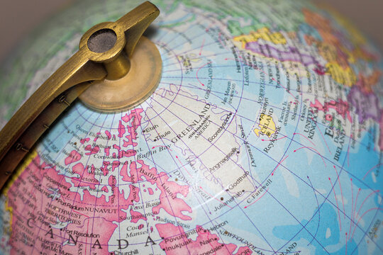 Greenland, with Denmark crossed out on globe map with America underneath