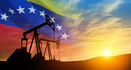 The change in oil prices. Oil price cap concept. Oil drilling derricks at desert oilfield with Venezuela flag. Crude oil production from the ground. Petroleum production.