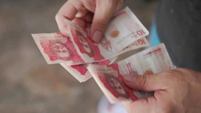 Hands Counting Ten Thousand Colombian Peso Bills Money Video Recorded in 4K at 60fps