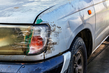 Broken headlight on car and sealed with transparent tape. Broken car headlight repaired with scotch...