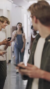 Man, student and gossip with phone at school for fake news, online bullying and false rumor. Upset, male person and mobile with cruel comments, peer mockery and discrimination for social humiliation