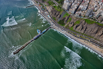 La Rosa Náutica, from a breathtaking aerial perspective. Perched elegantly on a private jetty extending into the Pacific Ocean, this Victorian-style restaurant has been a symbol of Miraflores 