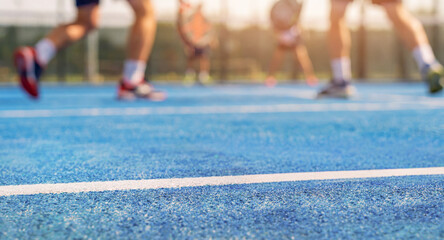 blurred people playing padel in outdoor court © ronstik