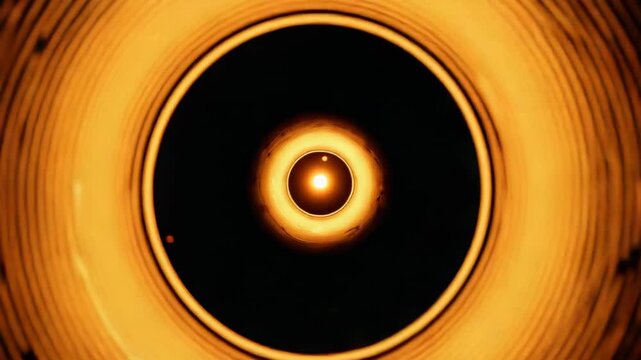 Brightening annular core forming inner ring while expanding ridges inside dark void, revealing dot