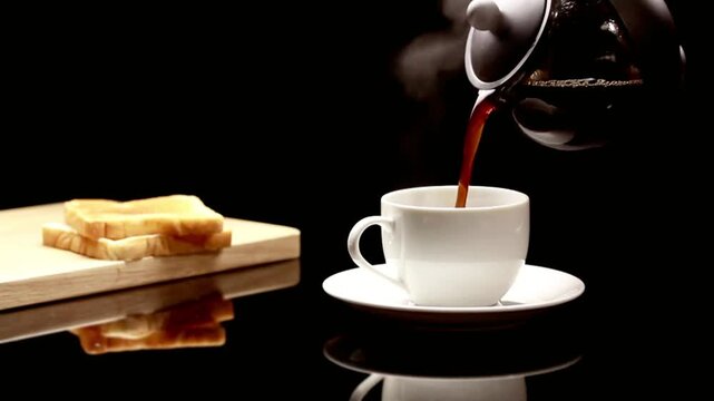 Minimalist breakfast scene with black coffee pouring and toasted bread on a dark reflective surface