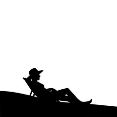 The silhouette of a woman sunbathing on the beach