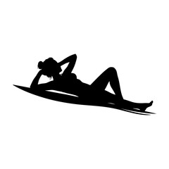 The silhouette of a woman sunbathing on the beach