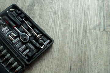 Socket Wrench Tool Set in Case on Wooden Background