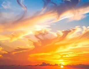 Vibrant golden and orange sunset sky filled with dramatic, wispy clouds against a soft blue backdrop.