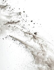 Dynamic high-speed shot capturing dark dust and debris exploding against a bright white background.