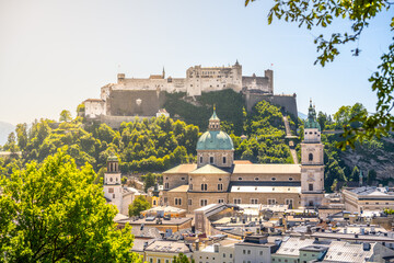 Salzburg showcases its majestic castle perched on the hill, surrounded by lush greenery. The city...