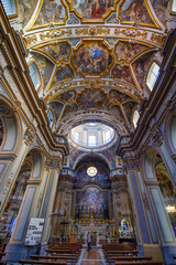Obraz premium The Church of San Nicola alla Carita in Naples, Italy with ornate frescoed ceilings, marble columns in baroque style.Ornate Baroque ceiling frescoes by Francesco Solimena