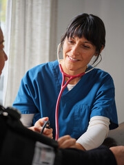 Native American nurse practitioner with stethoscope checks blood pressure