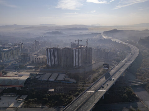 Aerial view of the Shri Atal Bihari Vajpayee Trans Harbour Link cutting through the urban sprawl under a hazy sky, Mumbai, Maharashtra, India.
