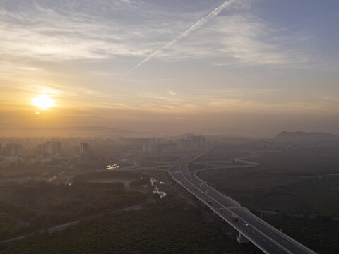 Aerial view of the Shri Atal Bihari Vajpayee Trans Harbour Link at sunrise, a ribbon of concrete cutting through the landscape, Mumbai, Maharashtra, India.