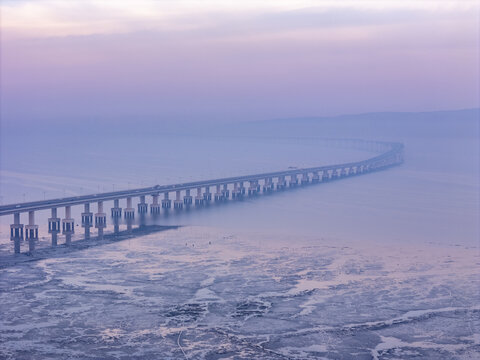 Aerial view of the hazy Shri Atal Bihari Vajpayee Trans Harbour Link stretching across the water under a pastel sky, Mumbai, Maharashtra, India.