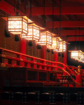 Kyoto, Japan - 18 January 2026: View of glowing lanterns casting a warm light on the vivid red lacquered wooden architecture of Fushimi Inari-taisha shrine.