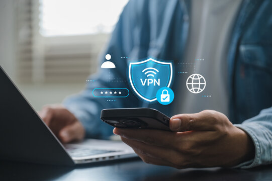 VPN security concept with user activating secure connection on smartphone while working on laptop at home, showing mobile internet protection, encrypted data access, and online privacy tools