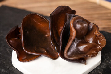 Obraz premium Chocolate Ear-Shaped Candies on White Plate, Gourmet Dessert