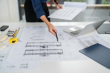woman architect works on design blueprints in an office