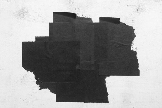 Torn black city poster close-up on white background