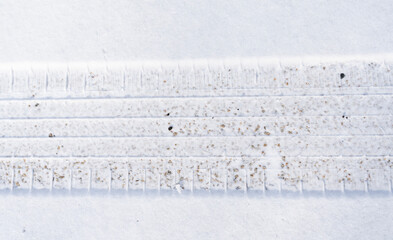 close up on tire tracks in the snow