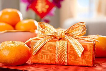 Celebrate with a bright orange gift and fresh tangerines in a festive setting during a special occasion