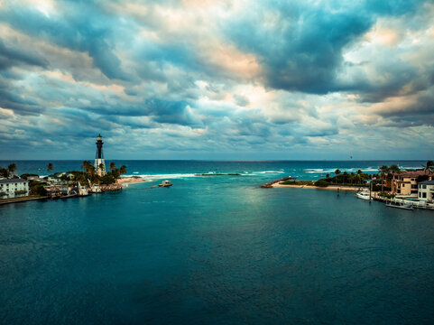 Dramatic cloudy sunrise at Hillsboro Inlet Lighthouse in Deerfield Beach, Florida, captured from Lighthouse Point. 