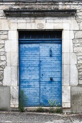 Ancient blue door in the medieval village of Martel in France