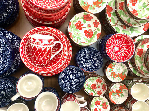 Colorful ceramic plates, cups, mugs display. Beautiful artisan crafts