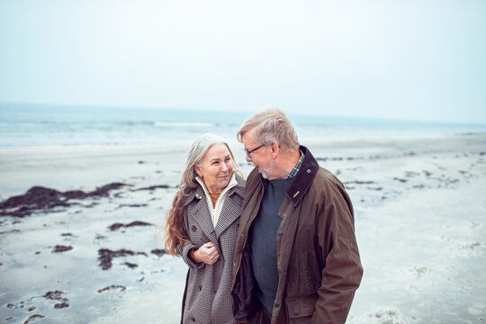 Senior couple walking together on quiet beach