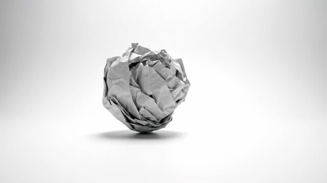 Wrinkled Paper Ball: A close-up shot of a crumpled paper ball, symbolizing discarded ideas, failures, or the creative process.