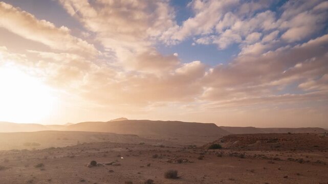 Timelapse: dramatic cloudy sky at sunset in Dahar mountains desert landscape in southern Tunisia, arid plateau, remote wilderness, Sahara fringe, travel destination, Ghomrassen, Africa